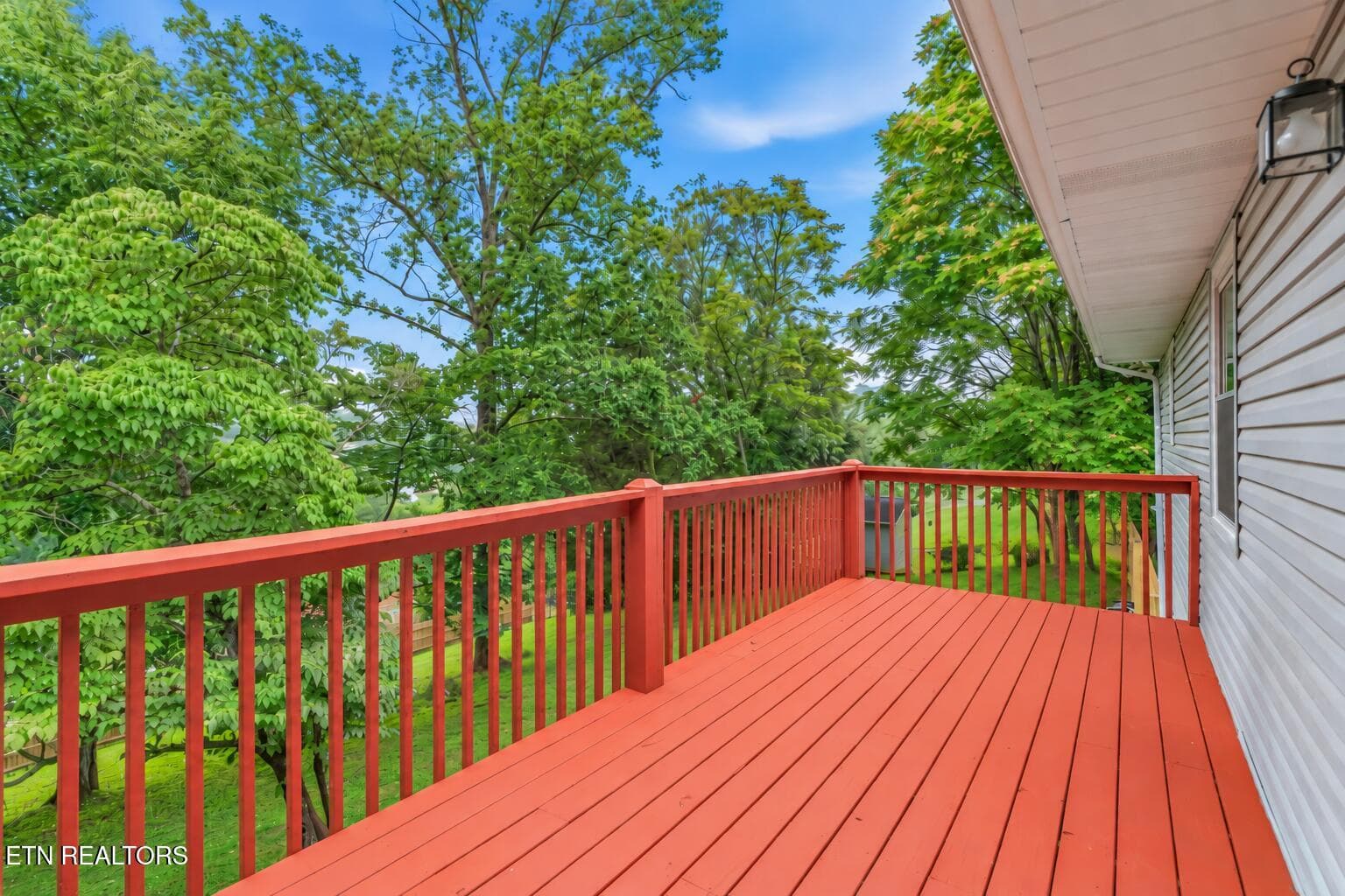Empty Red Deck Overlooking Lush Backyard - 1221 Laurel Rd, Clinton, TN 37716