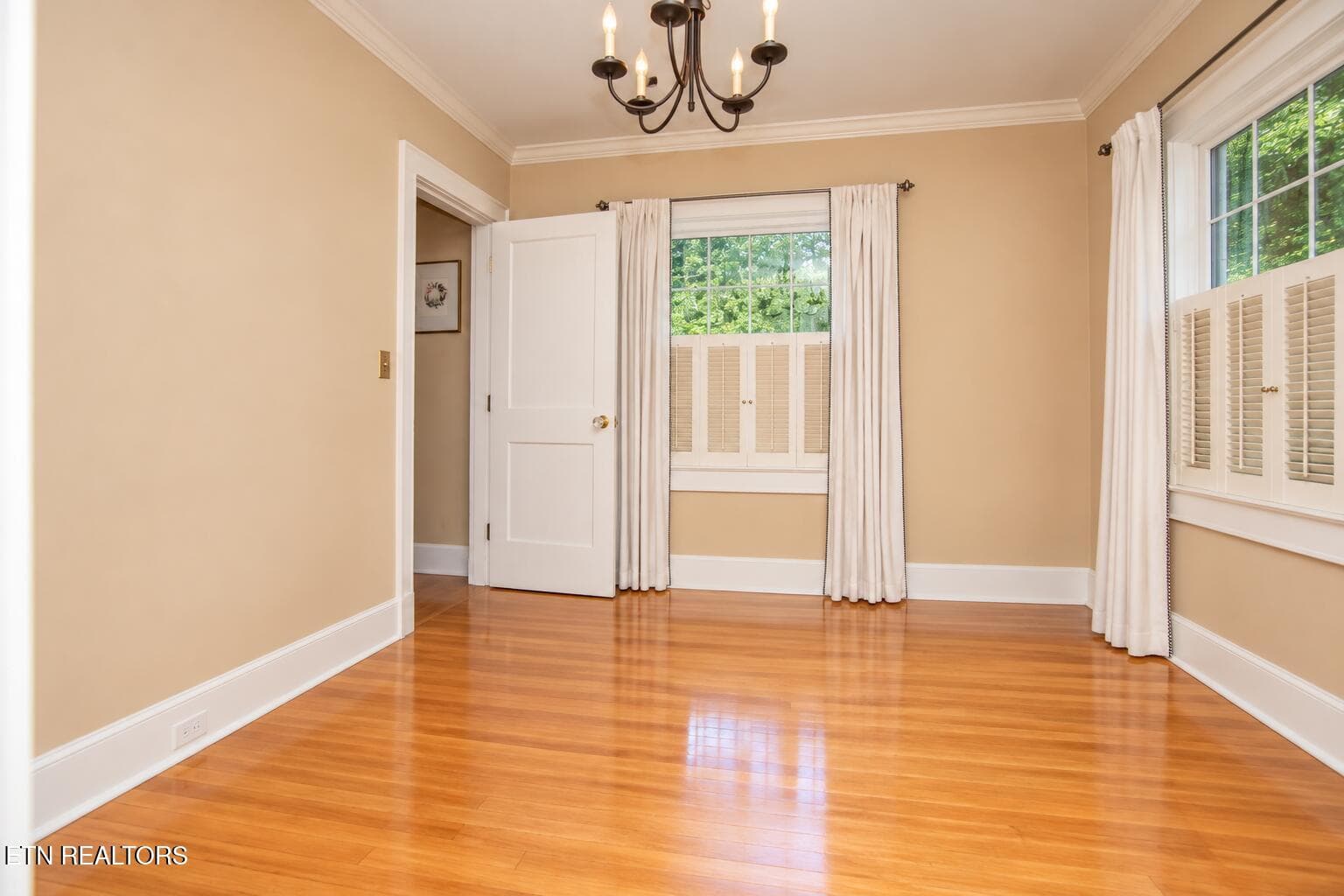 Sunlit Empty Room with Chandelier - 6809 Nubbin Ridge Drive, Knoxville, TN 37919