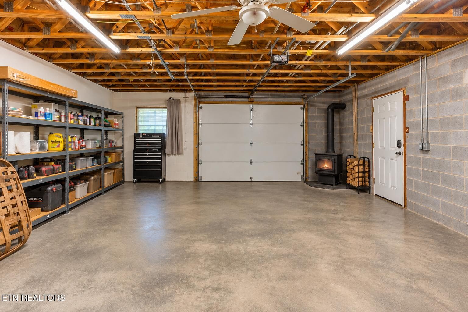 Organized Garage with Glowing Wood Stove - 1668 Deerwood Rd, Newport, TN 37821