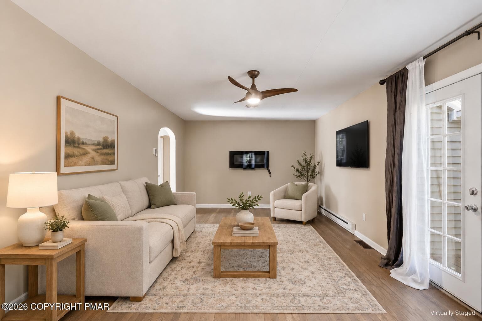 Wall-mounted TV above cream armchair - 105 Periwinkle Lane, Stroudsburg, PA 18360, Stroudsburg