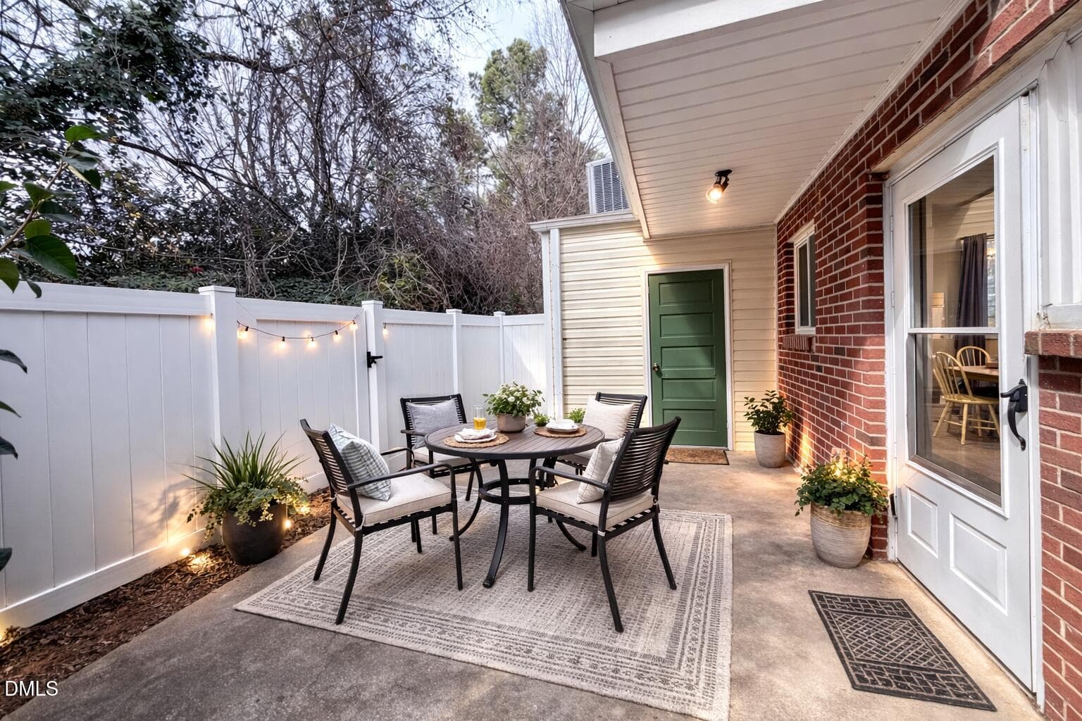 Cozy outdoor dining patio with lights - 2375 Champion Court, Raleigh, NC 27606, Raleigh