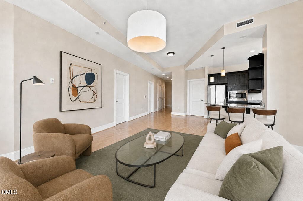 Living_Room- Staged Virtually - 400 W North Street 826, Raleigh, NC 27603, Raleigh
