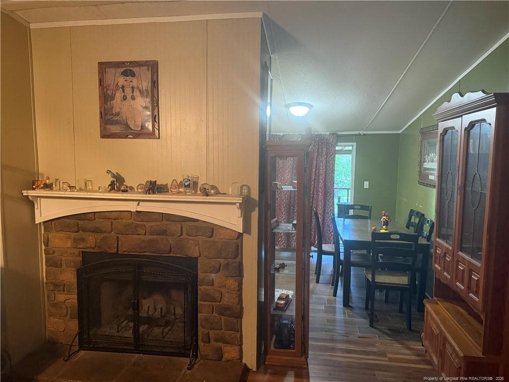 fire place and view of dining area - 15041 Smith Road, Gibson, NC 28343