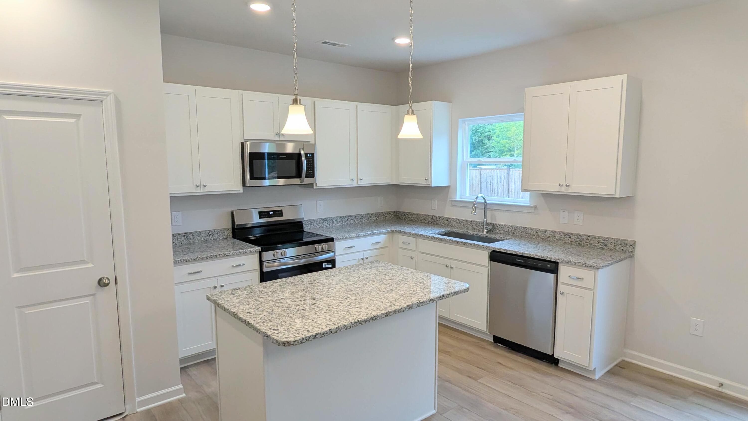 Sleek Granite and White Cabinetry - 71 Chardonnay Drive, Lillington, NC 27546