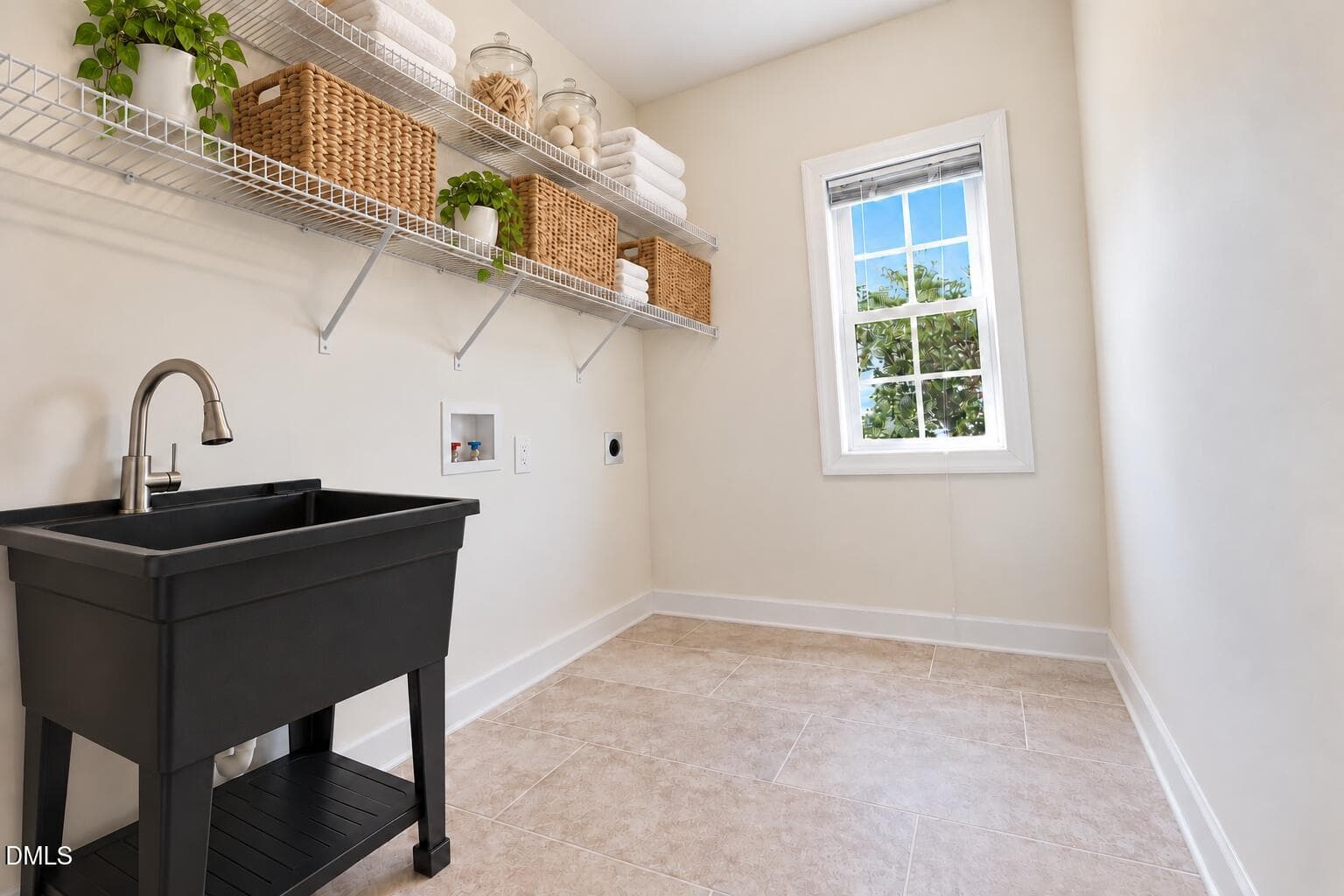 Neat laundry room with orderly shelves - 1524 Wood Spring Court, Raleigh, NC 27614