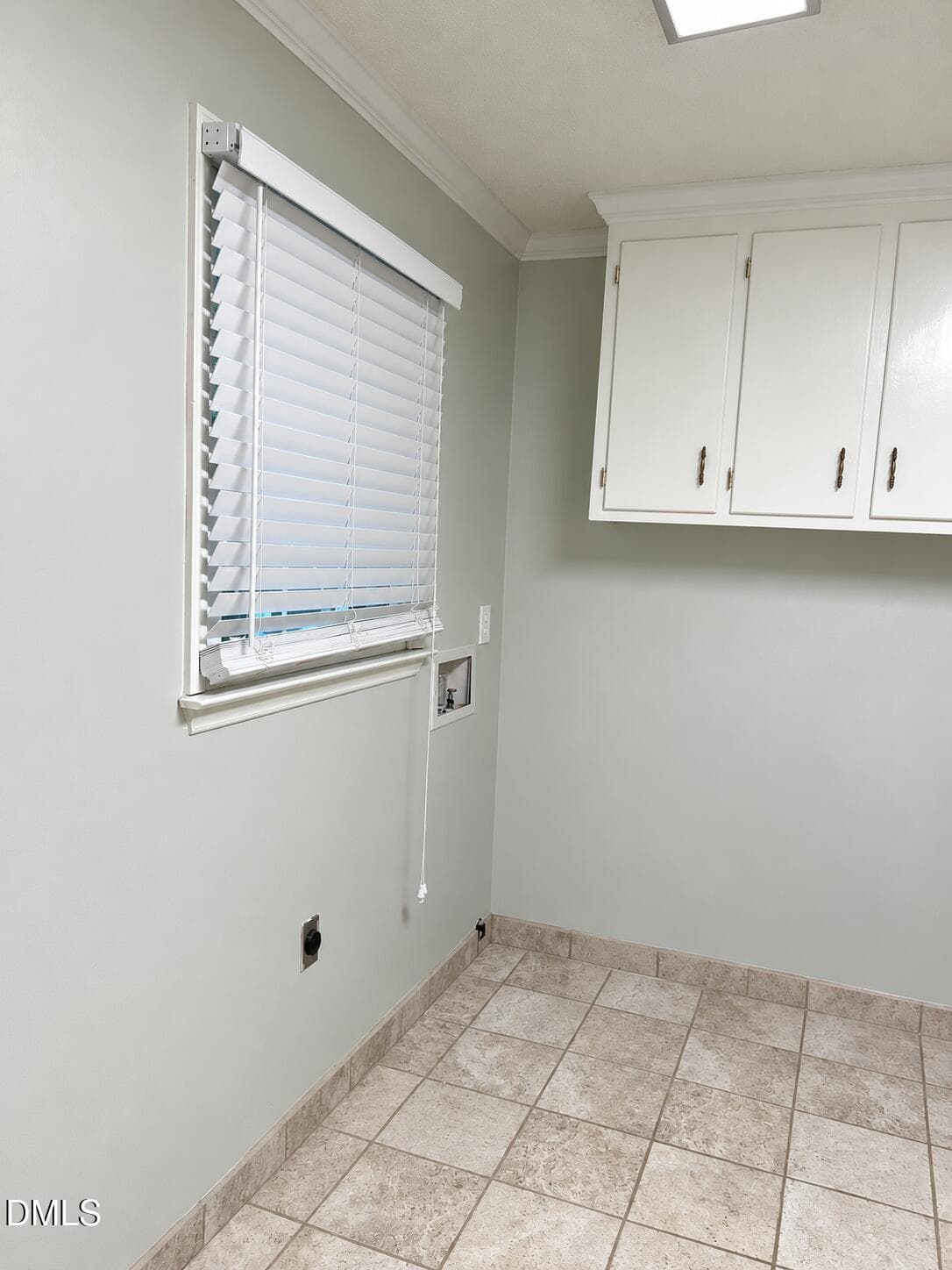 Empty laundry room with white cabinets - 100 Moray Court, Cary, NC 27511