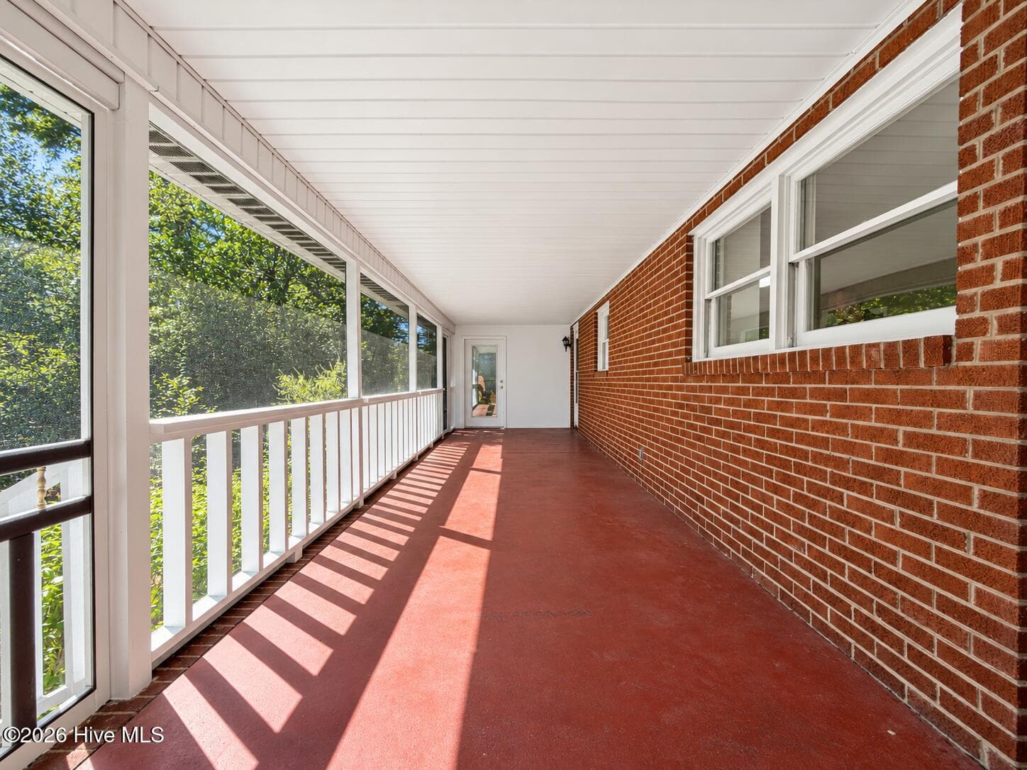 The room at the end of the screened porch is the flex sunroom type space off the primary suite and knotty pine paneled room. - 320 Northern Boulevard, Wilmington, NC 28401