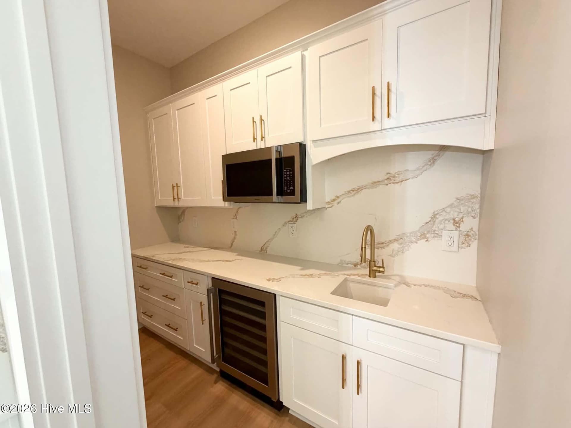 Butler's pantry with microwave, wine fridge, custom counters, backsplash and cabinet pulls. - 550 Glenburnie Street NW, Calabash, NC 28467