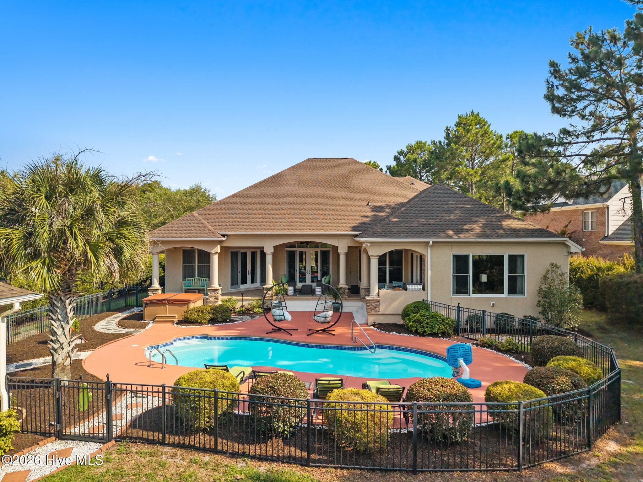 Pool area is fenced and offers privacy with mature plantings - 3858 Ridge Crest Drive, Southport, NC 28461