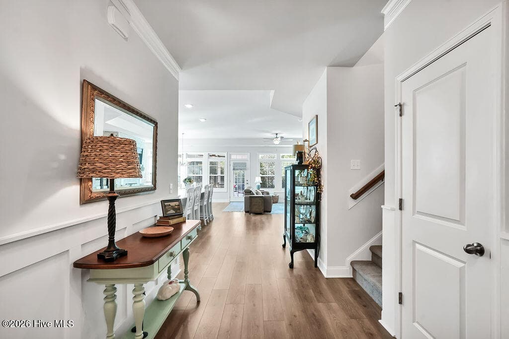 A wide foyer transitions into an open great room consisting of a large living room, enormous kitchen, and dining area. - 142 Rice Marsh Way, Wilmington, NC 28412