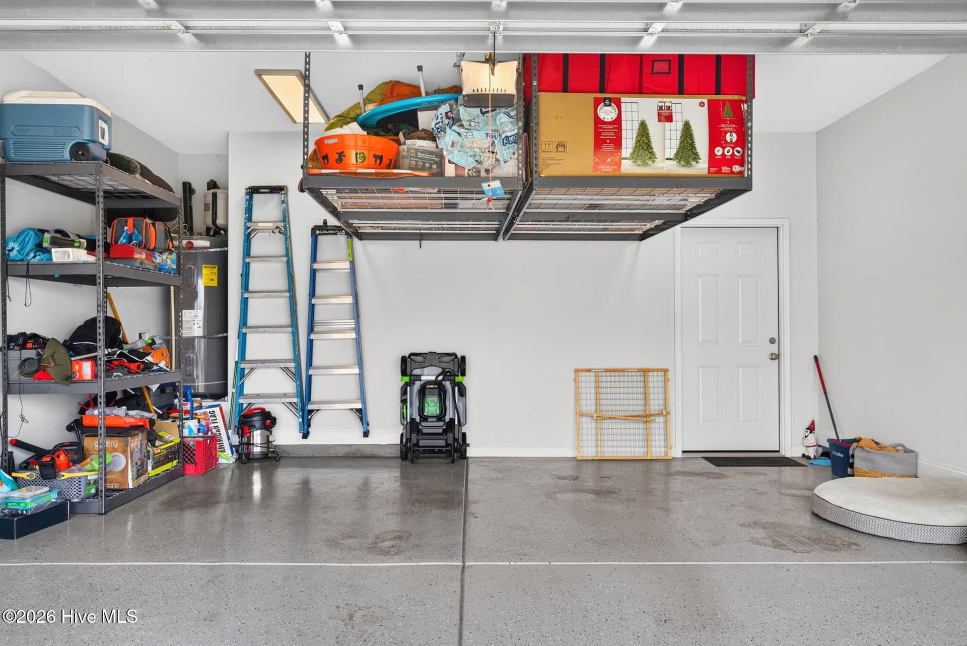 The attached two-car garage offers overhead storage, shelving, and additional space for tools, equipment, and recreation gear. - 139 Eagle Claw Drive, Calabash, NC 28467
