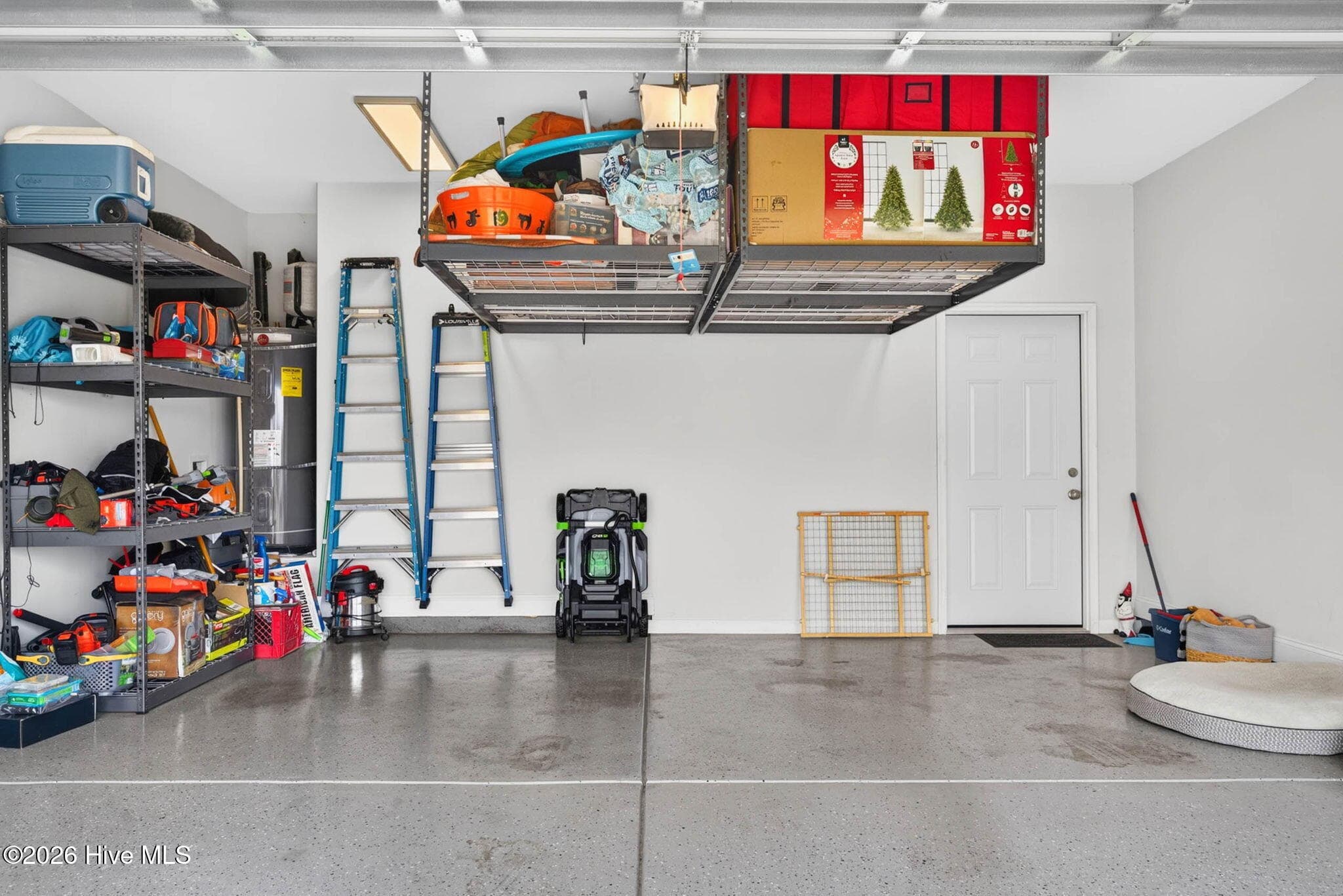 The attached two-car garage offers overhead storage, shelving, and additional space for tools, equipment, and recreation gear. - 139 Eagle Claw Drive, Calabash, NC 28467