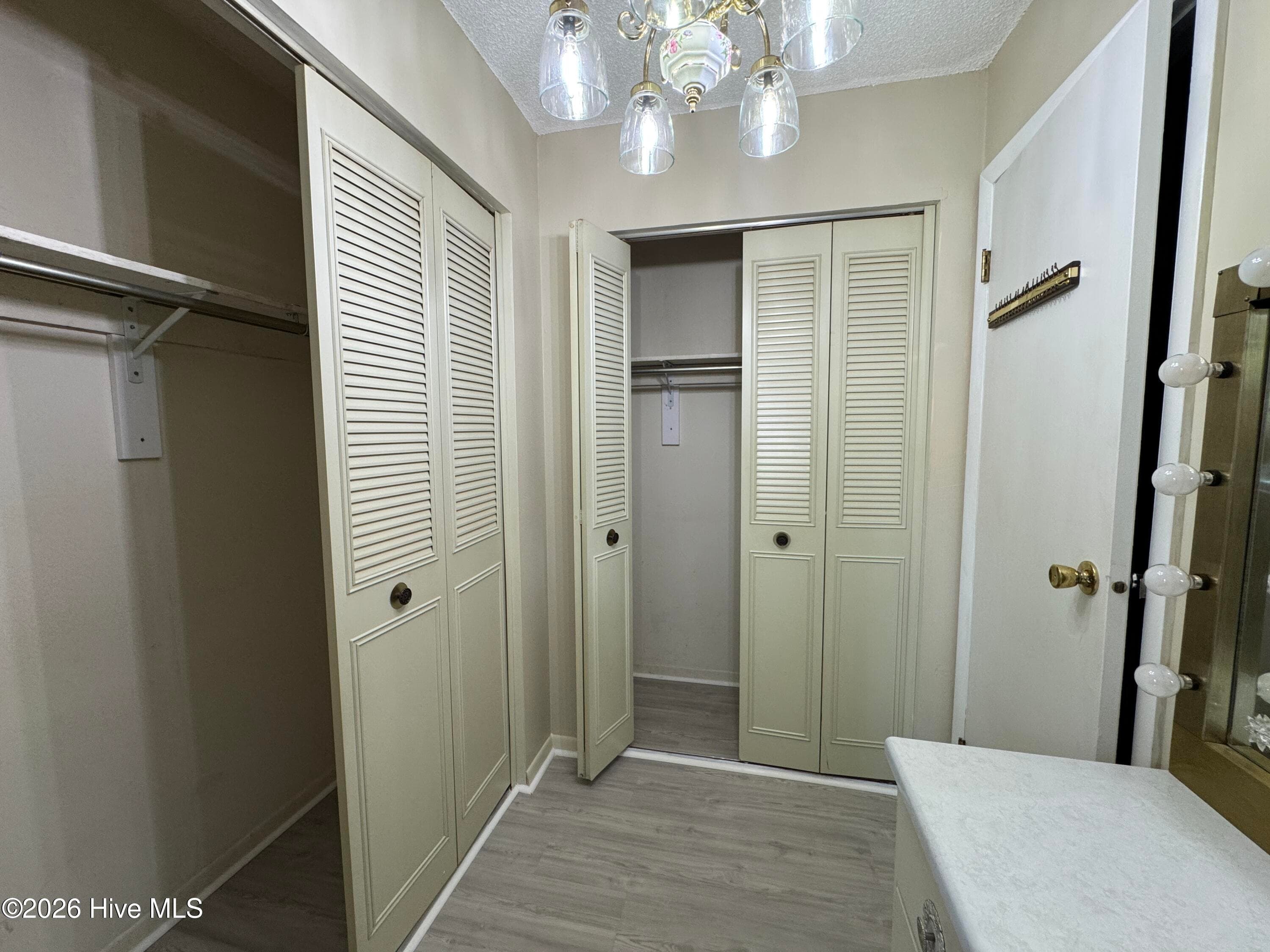 His and Hers Closets in a dressing area. Toilet and shower are through the door that is 'ajar'. - 118 Oakwood Drive, Havelock, NC 28532