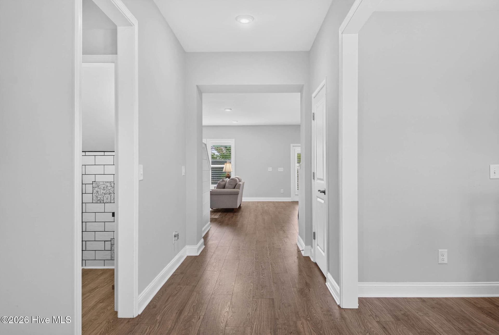 The bright entrance foyer welcomes you inside with high ceilings, luxury vinyl plank flooring, and an open layout. - 139 Eagle Claw Drive, Calabash, NC 28467