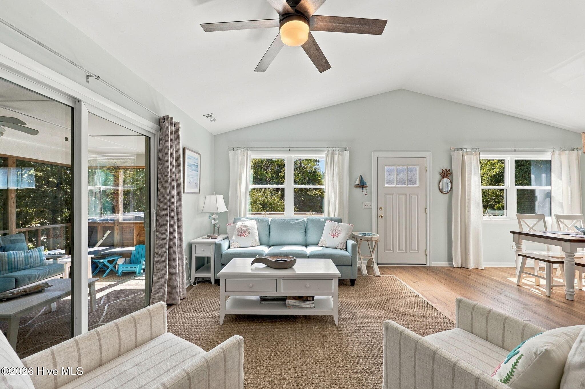 Living room opens to screened porch - 118 Periwinkle Drive, Emerald Isle, NC 28594