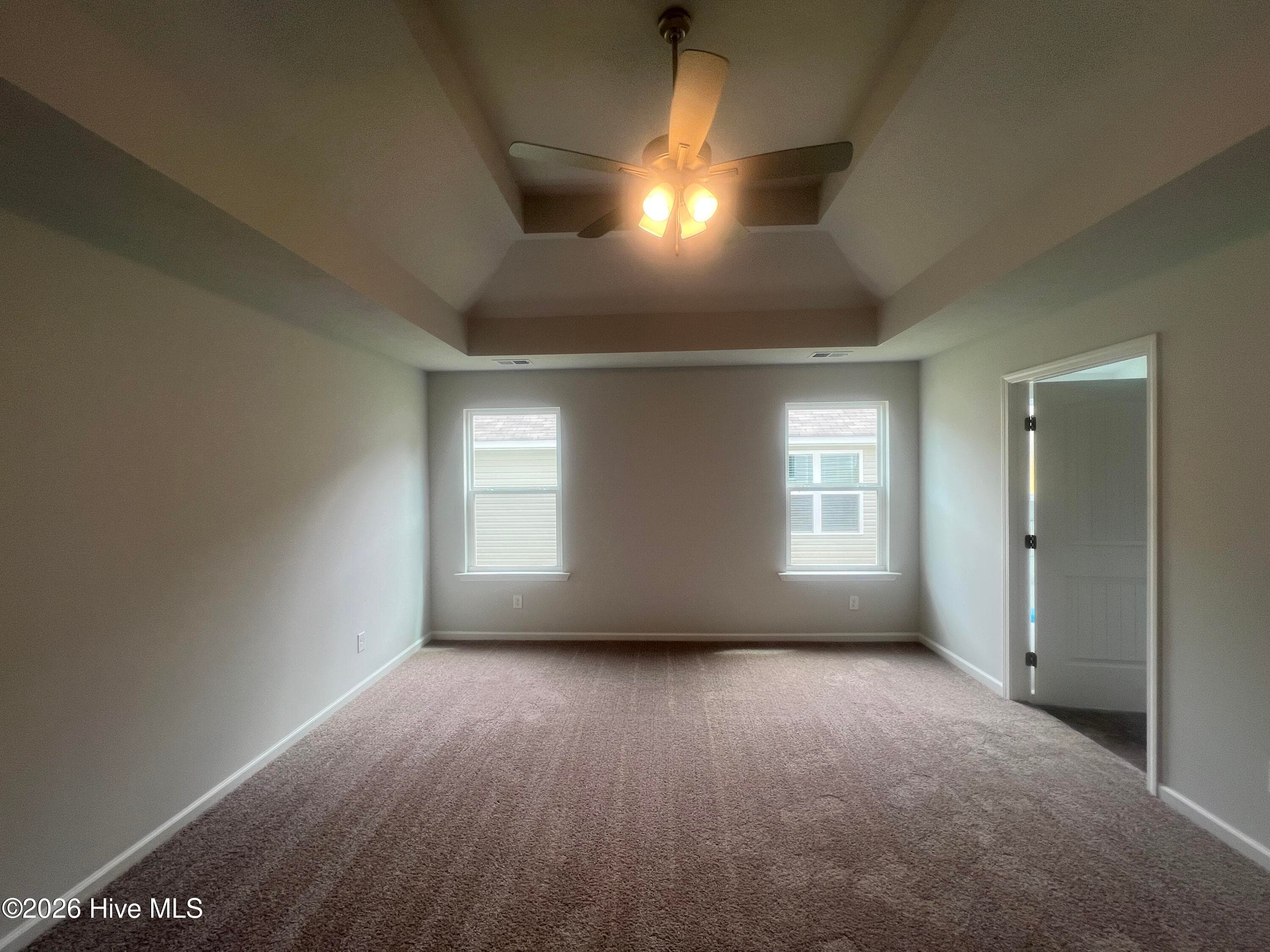 Primary bedroom with a nice tray ceiling. - 8887 Snelling Drive, Aiken, SC 29803