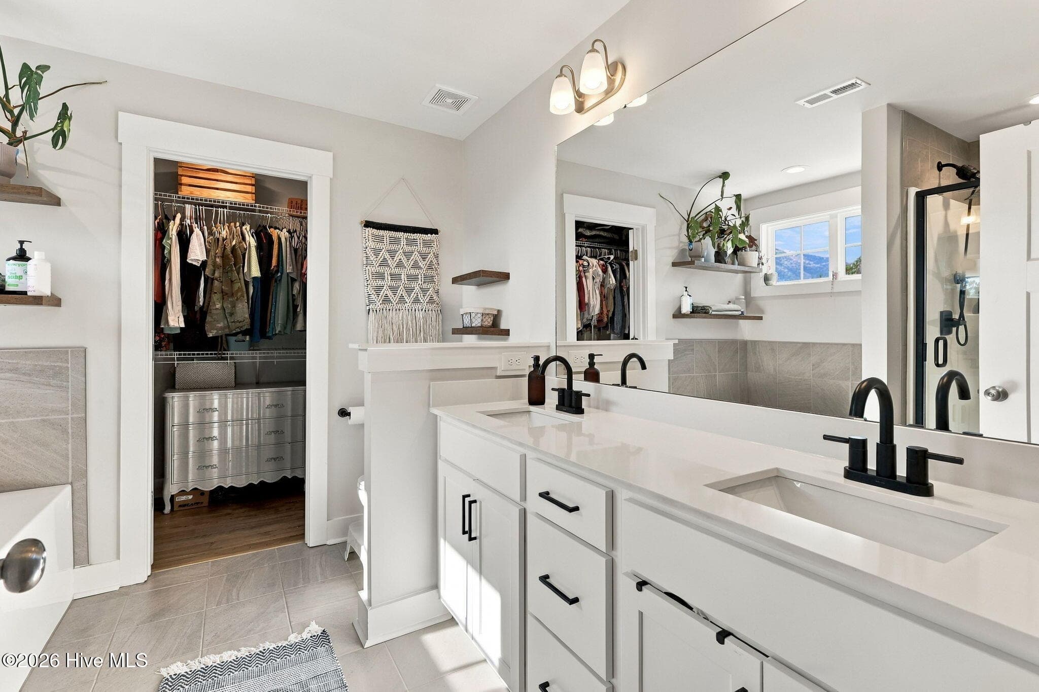Primary bathroom with double vanities. - 1400 Chason Road, Lumber Bridge, NC 28357