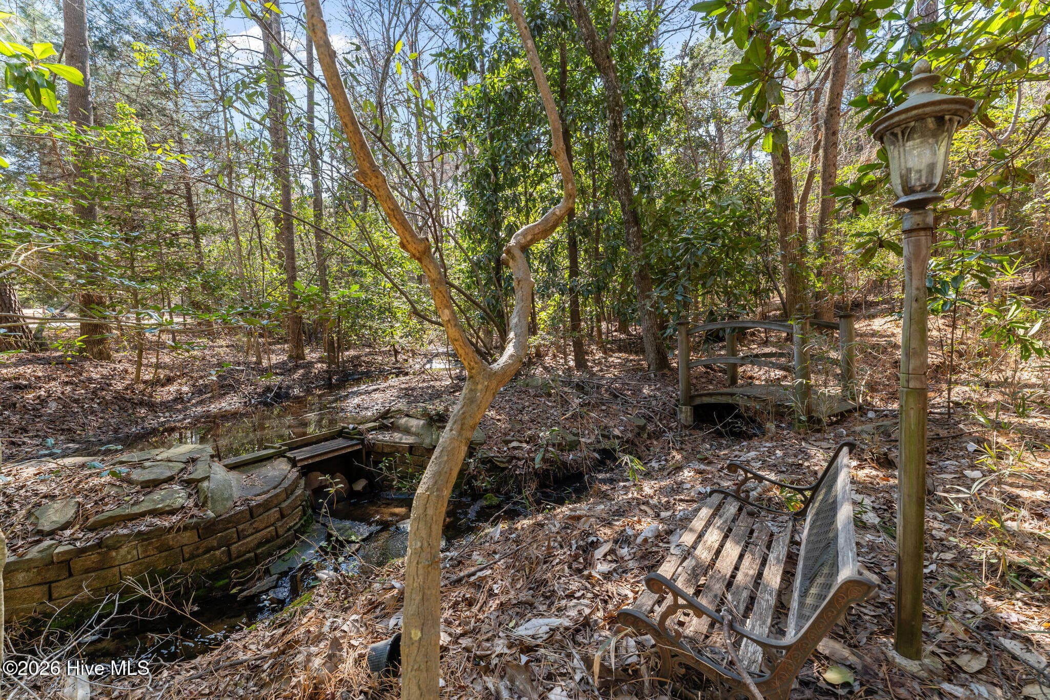 A bench is ready for kicking back and enjoying the solitude. - 22 Lochmere Drive, Pinehurst, NC 28374