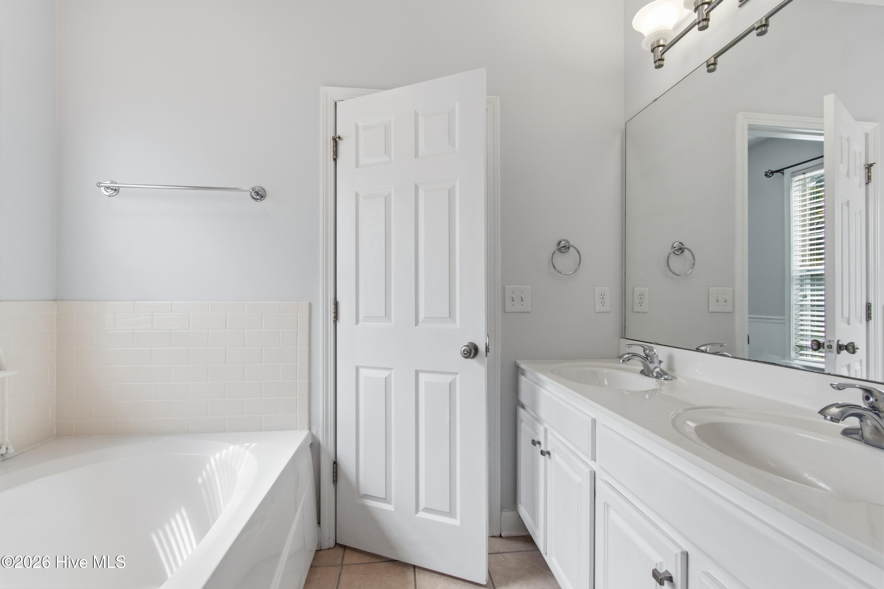 Primary bedroom en suite bathroom with dual sinks. - 709 E Pipers Glen, Shallotte, NC 28470