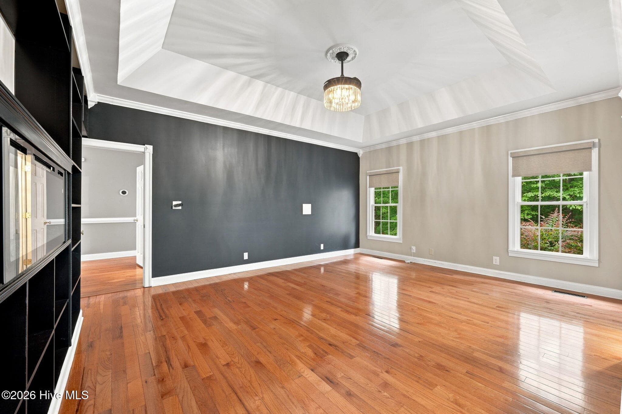 Primary bedroom suite with accent wall and smart shades - 407 Rustic Court, Pollocksville, NC 28573