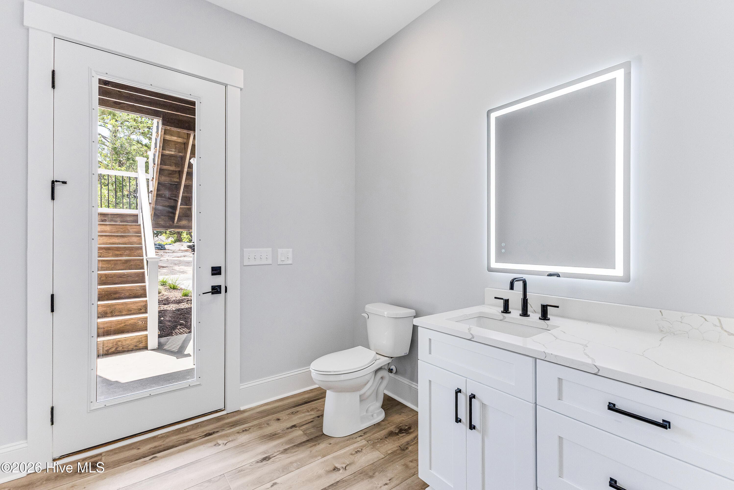 I love this touch. Wash all the sand off of you in the outdoor shower right outside that door and come on inside to this beach bath / mud room. - 5113 Minnesota Drive SE, Southport, NC 28461
