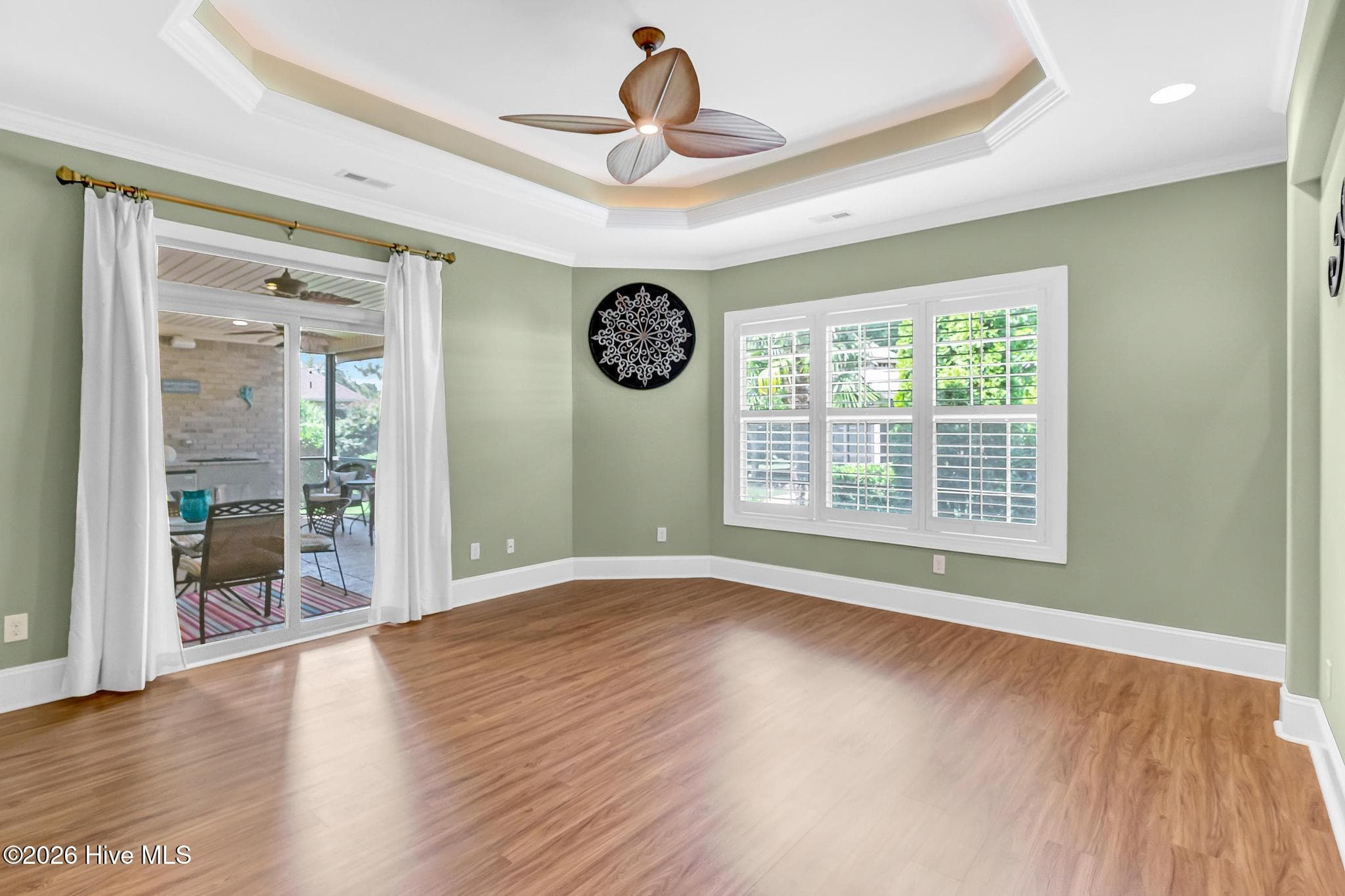 Primary bedroom, door out to the screened in sunroom. - 2474 Sugargrove Trail NE, Leland, NC 28451