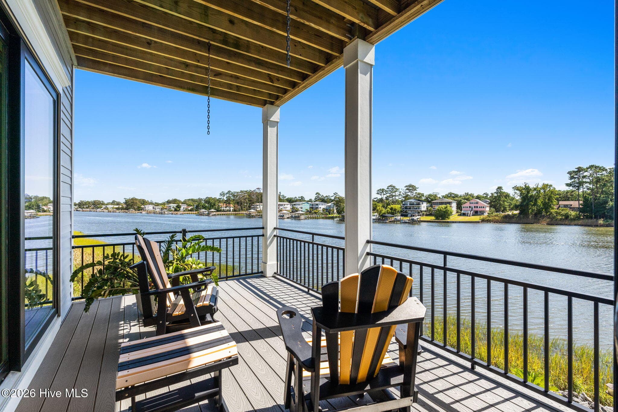 Covered porch accessible from Carolina Room or Primary Suite. Perfect spot for your morning brew - 2775 Long Bay Drive SE, Southport, NC 28461