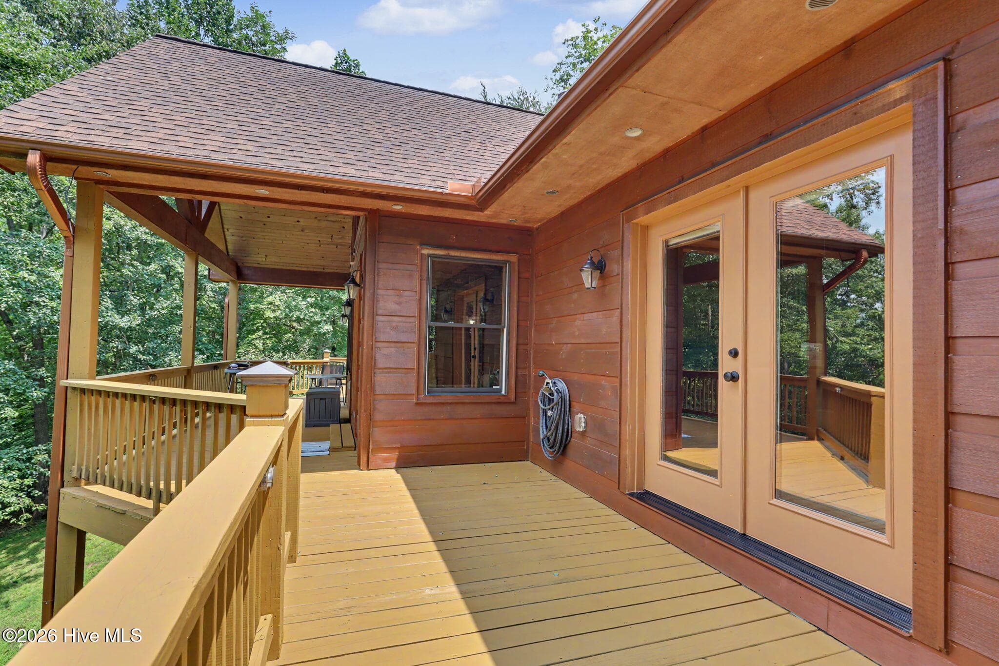 French doors connect the home's interior spaces directly to the deck. - 210 Majestic Drive, Hayesville, NC 28904