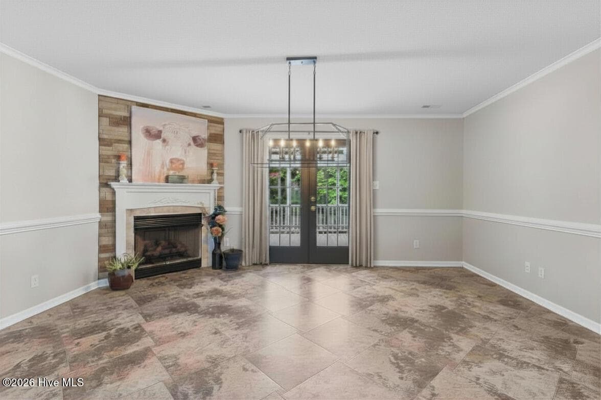 Living or Dining room with fireplace and glass doors opens to covered deck - 9184 Seaside Landing SW, Calabash, NC 28467