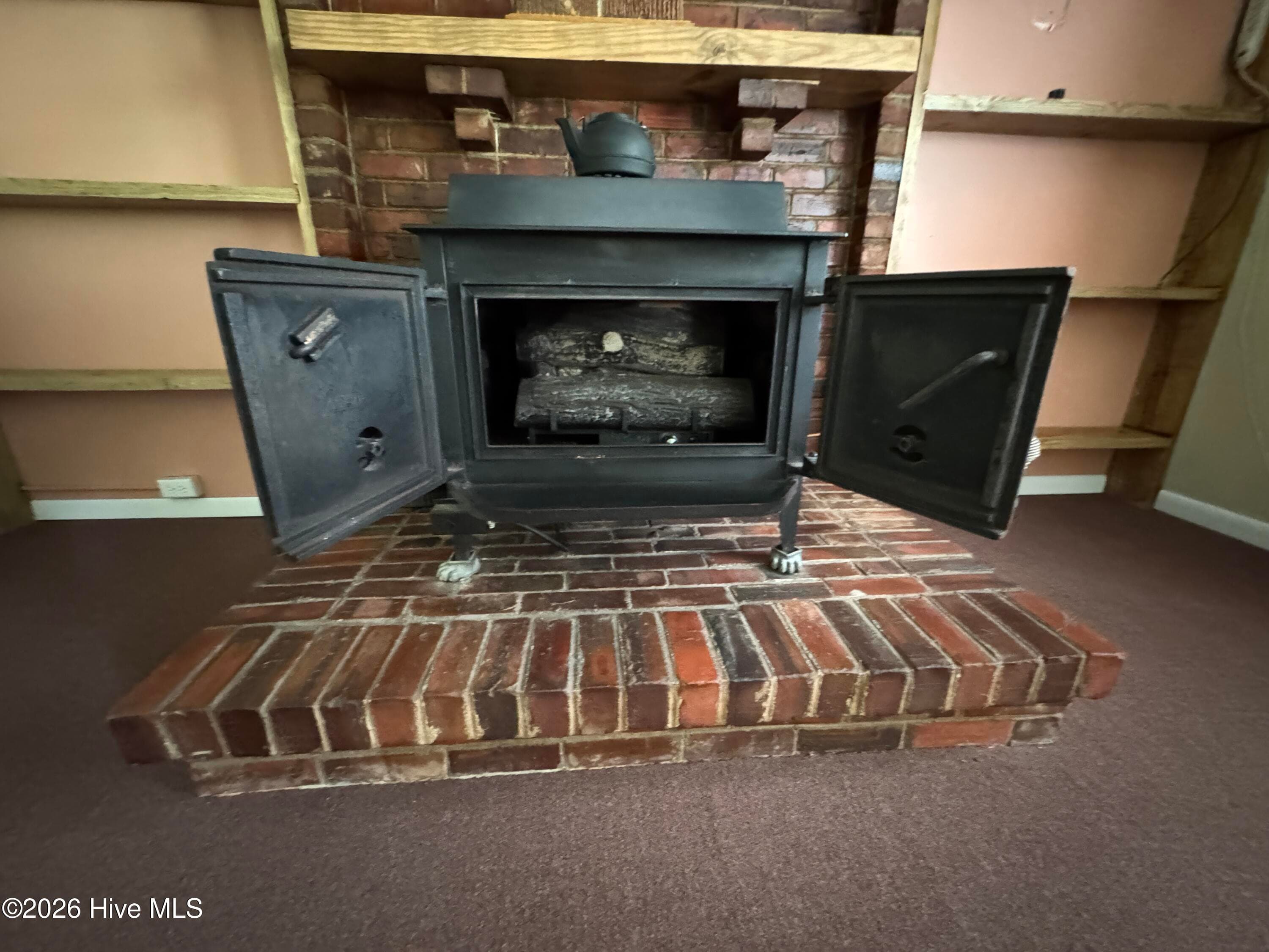 looks like a wood burning stove but has gas logs in there for now. - 118 Oakwood Drive, Havelock, NC 28532