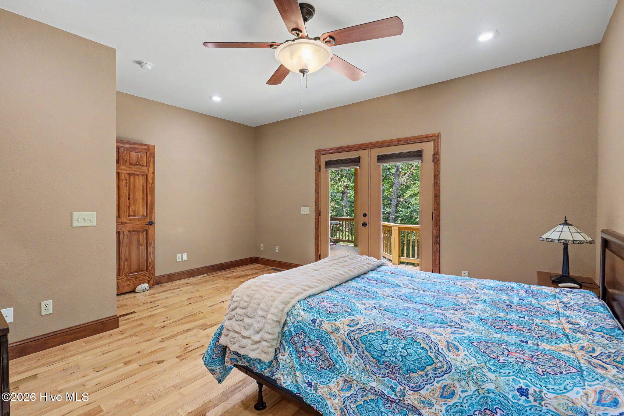 Hardwood floors and generous dimensions continue in the second main level bedroom. - 210 Majestic Drive, Hayesville, NC 28904