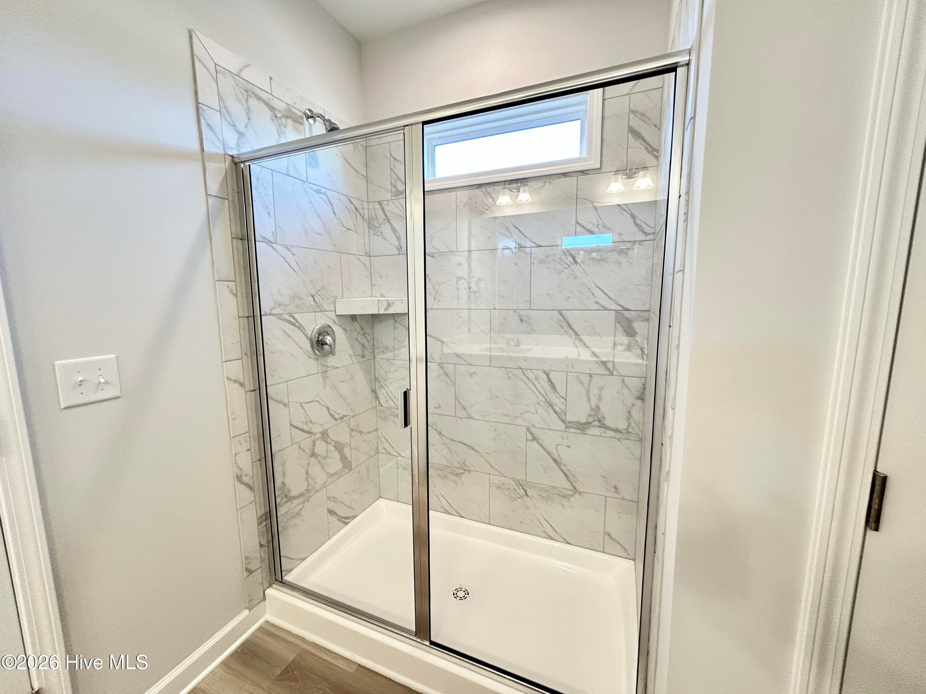 Primary Suite features a Private Bathroom with Tile Shower and Large Walk-in Closet - 4153 Workman Loop 68, Leland, NC 28451