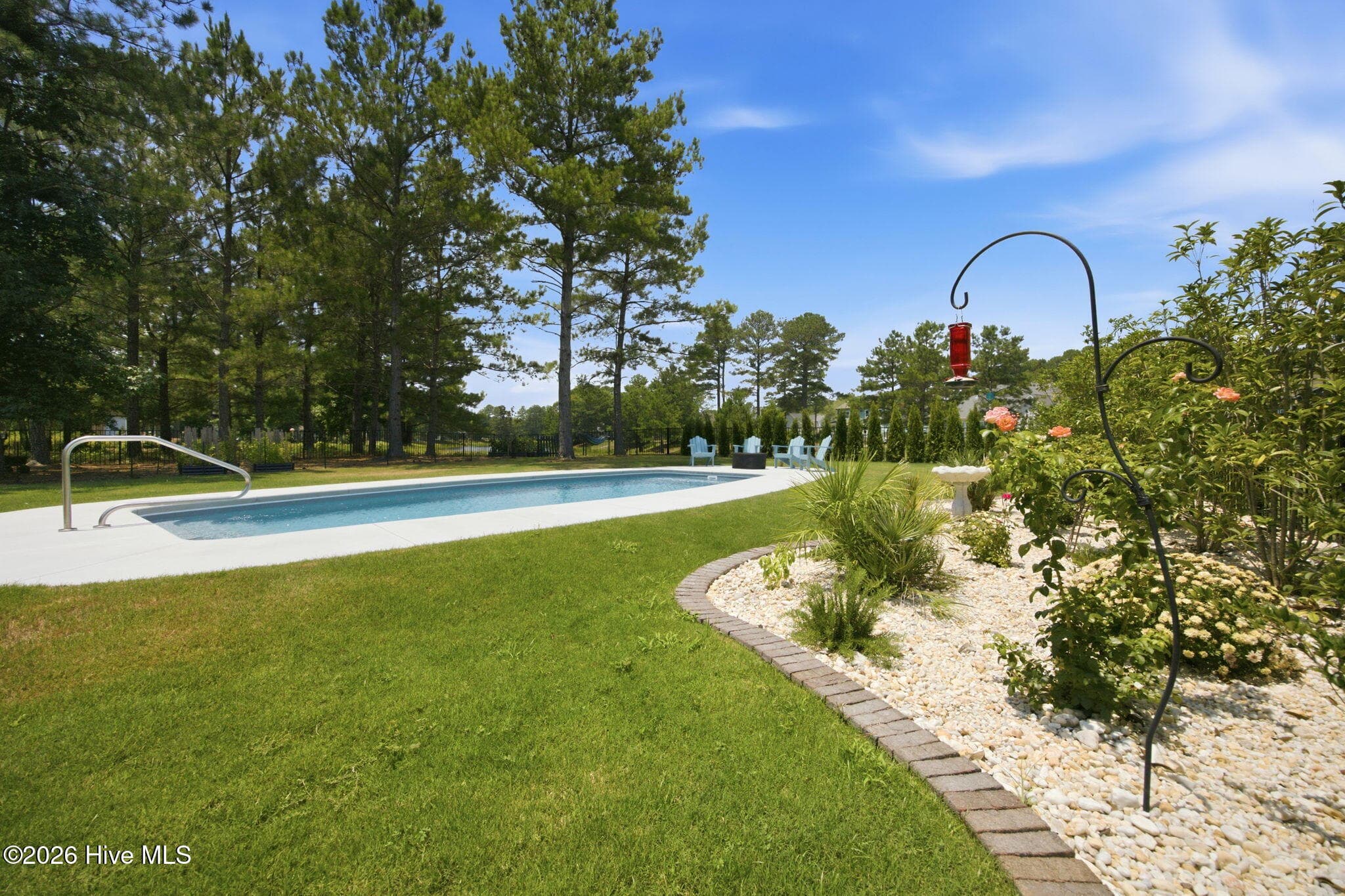 lush landscaping with 15 x 33 ft saltwater pool - 776 Breezewood Drive SE, Bolivia, NC 28422