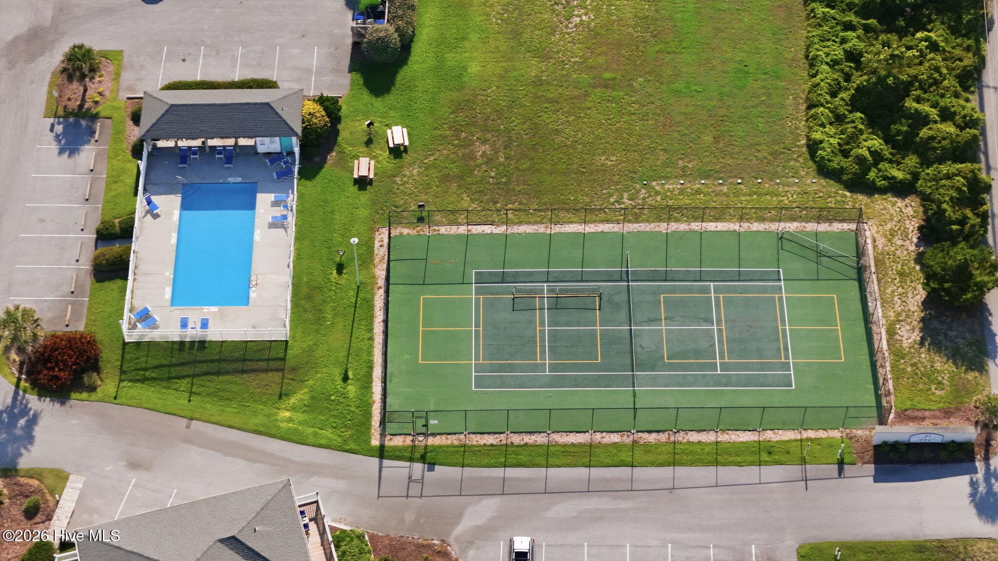 Pier Pointe amenities include two outdoor swimming pools, a tennis court, electric vehicle charging station, and private beach access. HOA dues include water, cable, and internet, adding convenience and value for owners. - 2801 Pier Pointe Drive B2, Emerald Isle, NC 28594
