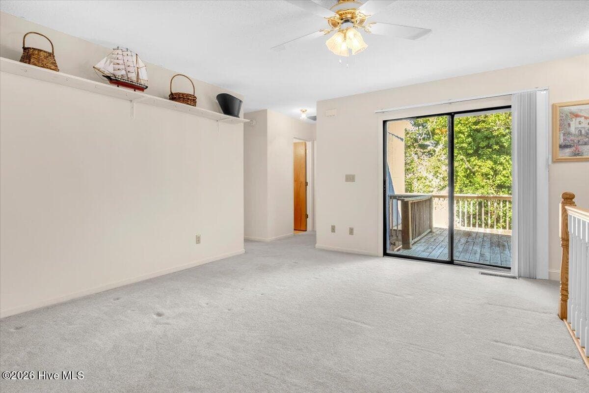 Sliding door from second family room onto upper deck - 109 NE 30th Street, Oak Island, NC 28465