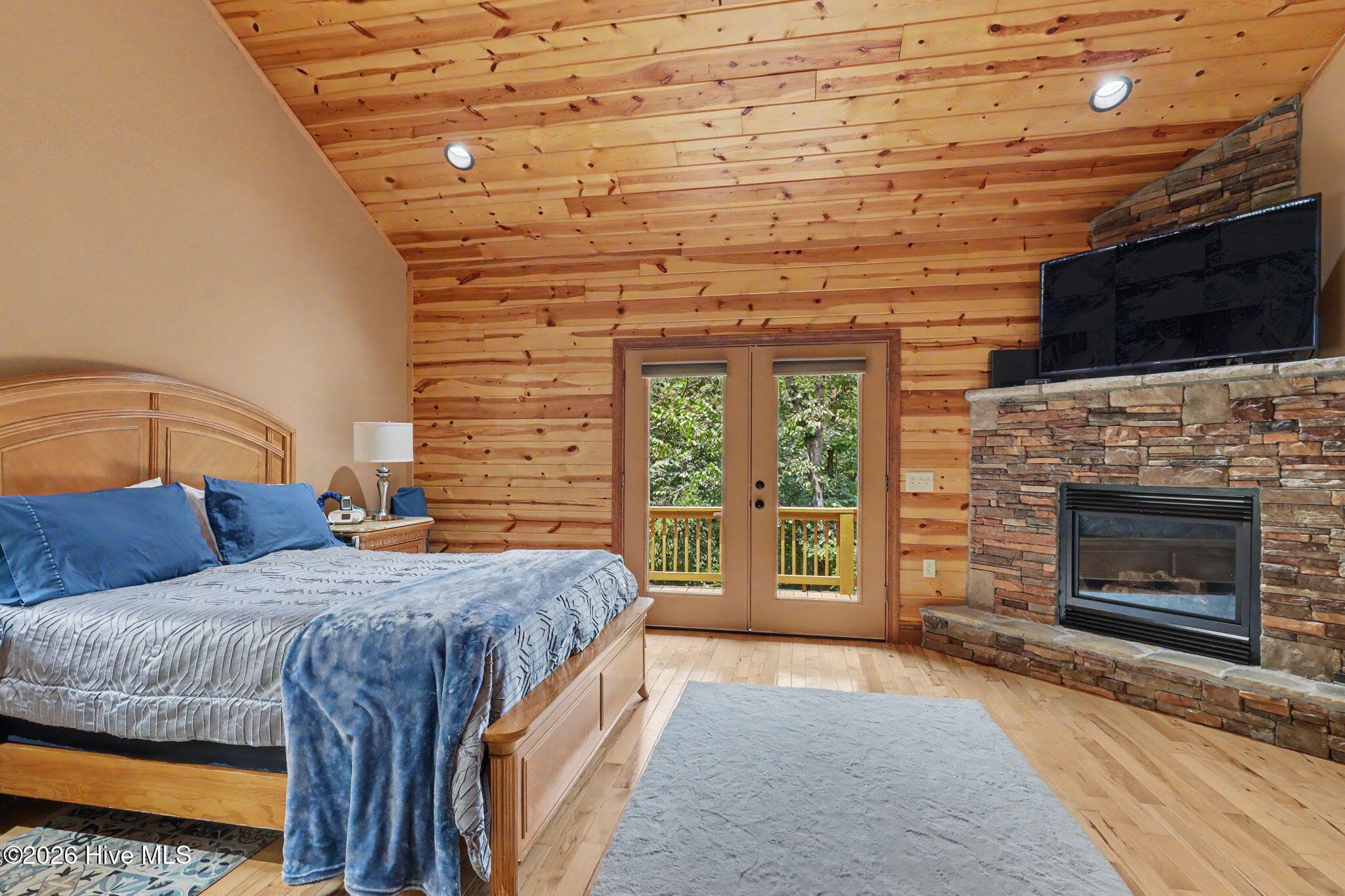 Primary bedroom combines generous proportions with warm natural finishes. - 210 Majestic Drive, Hayesville, NC 28904