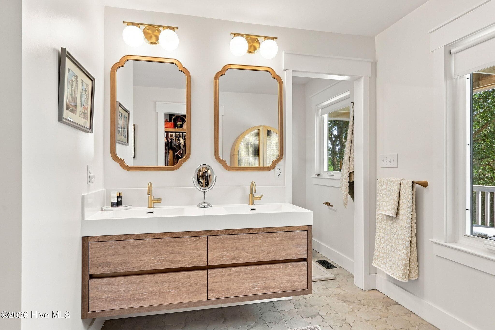 Spa-inspired primary bathroom featuring heated tile floors and a stunning custom-tiled walk-in shower. - 103 Georgia Street, Emerald Isle, NC 28594