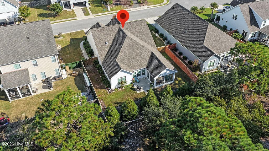 With its extended patio and enclosed 3-season room, this irrigated, beautifully landscaped sloping backyard is easy to maintain. - 142 Rice Marsh Way, Wilmington, NC 28412