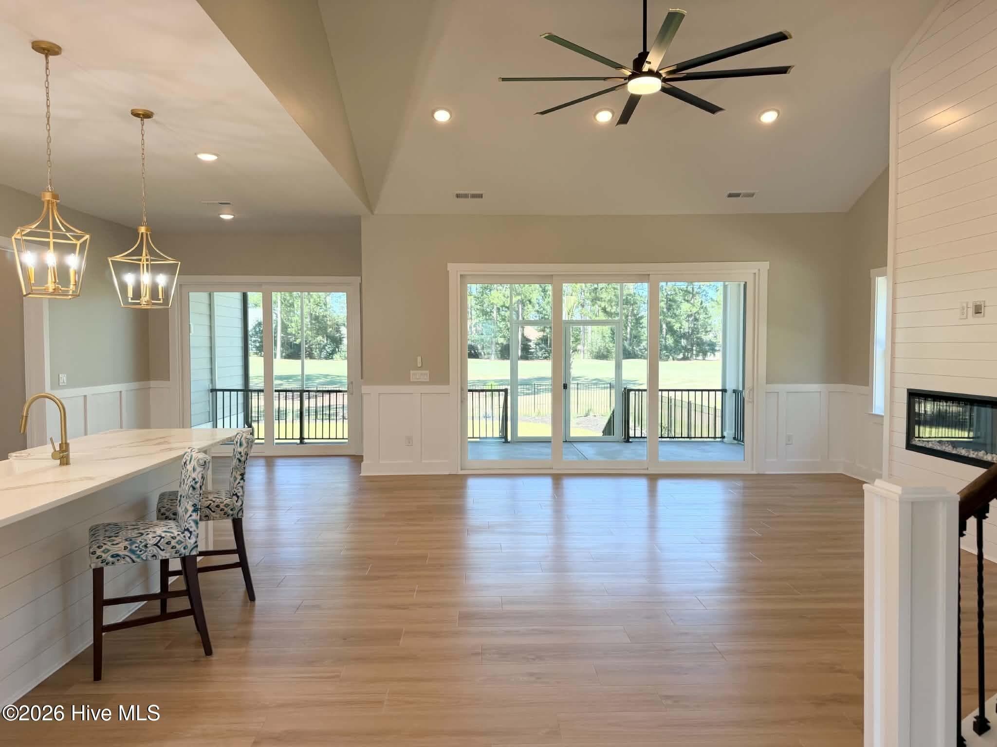 Great room area, upgraded Pergo flooring and lighting. Looking out onto upgraded screen porch. - 550 Glenburnie Street NW, Calabash, NC 28467