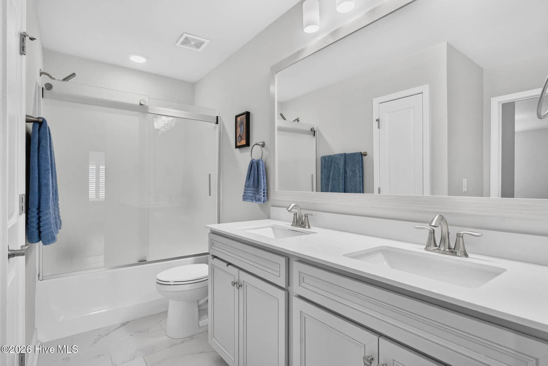 The upstairs full bathroom features an extended vanity, generous cabinetry, and a convenient shower and tub combination. - 139 Eagle Claw Drive, Calabash, NC 28467