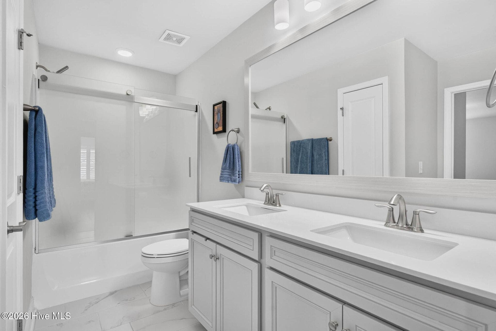 The upstairs full bathroom features an extended vanity, generous cabinetry, and a convenient shower and tub combination. - 139 Eagle Claw Drive, Calabash, NC 28467