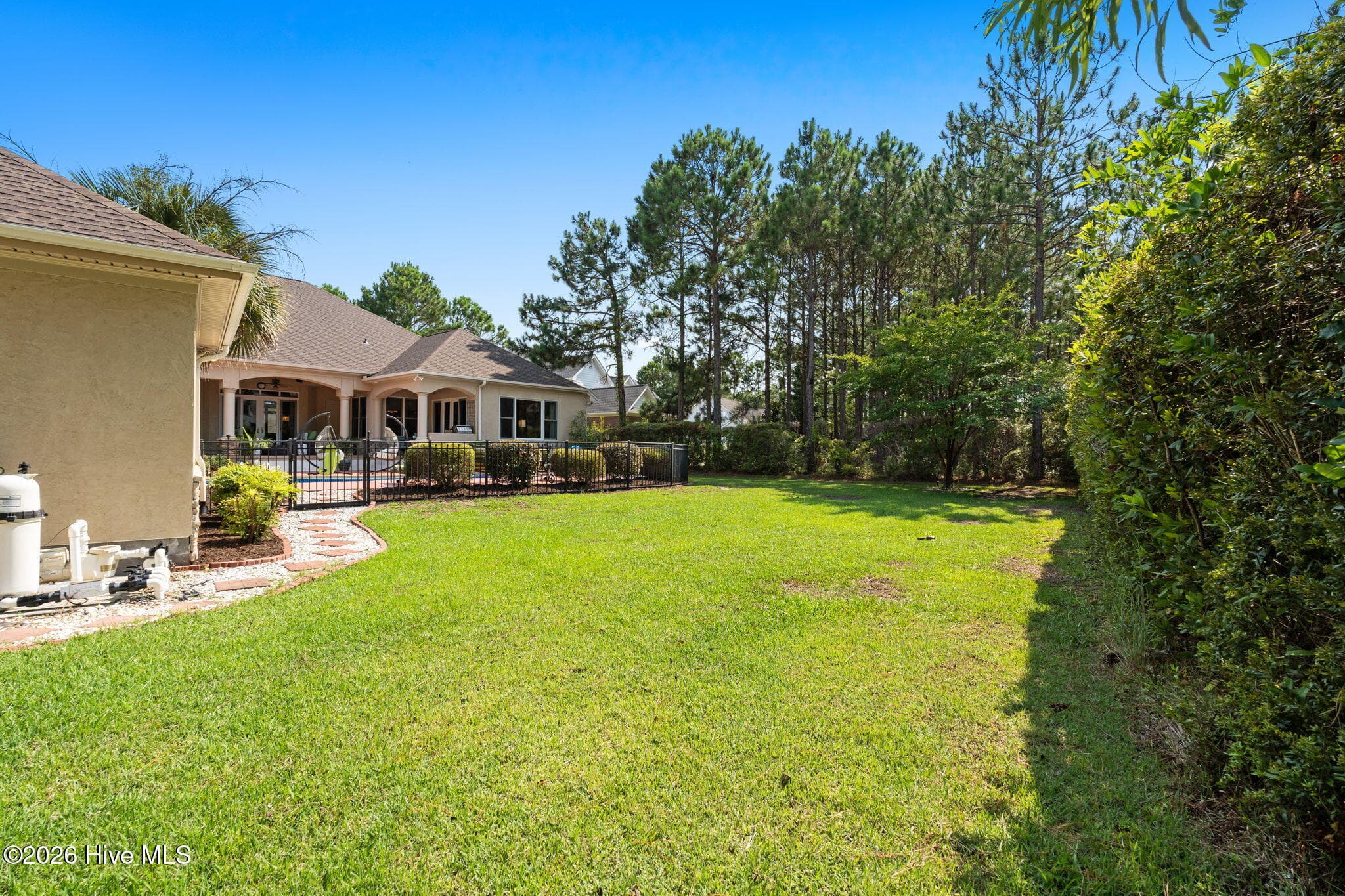 Enjoy this grassy area behind the pool - 3858 Ridge Crest Drive, Southport, NC 28461