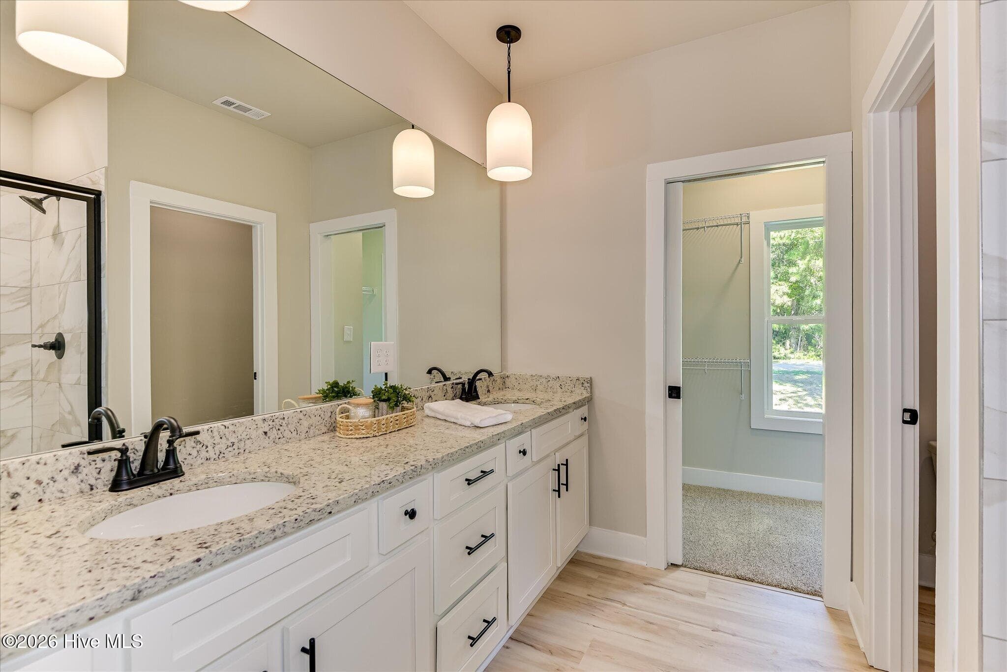 Primary Ensuite with double-sink vanity, tile shower, large walk-in closet - 1198 Sunset Cove, Tignall, GA 30668