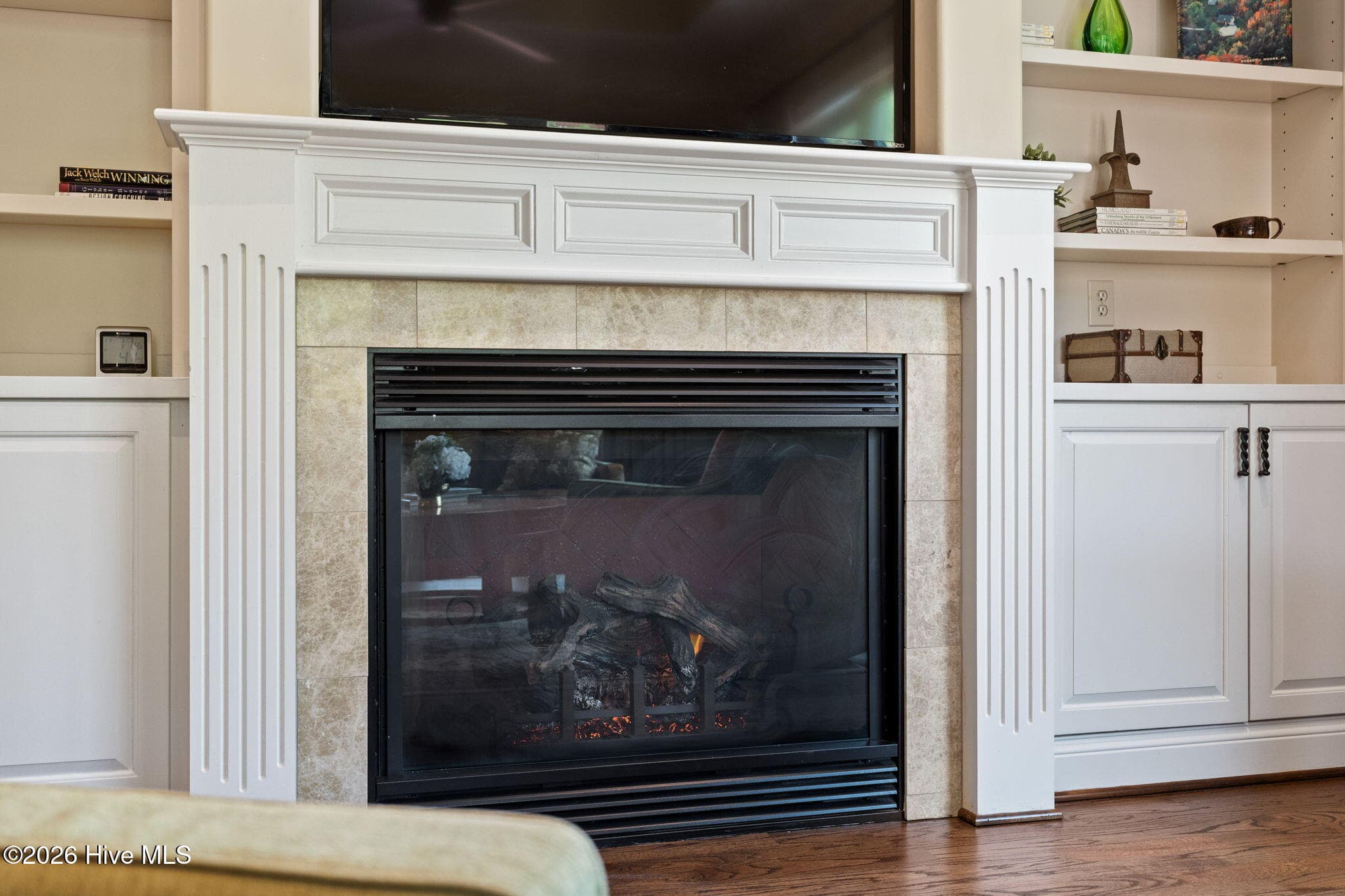 Fireplace with mantle flanked by built-in bookcases - 3858 Ridge Crest Drive, Southport, NC 28461