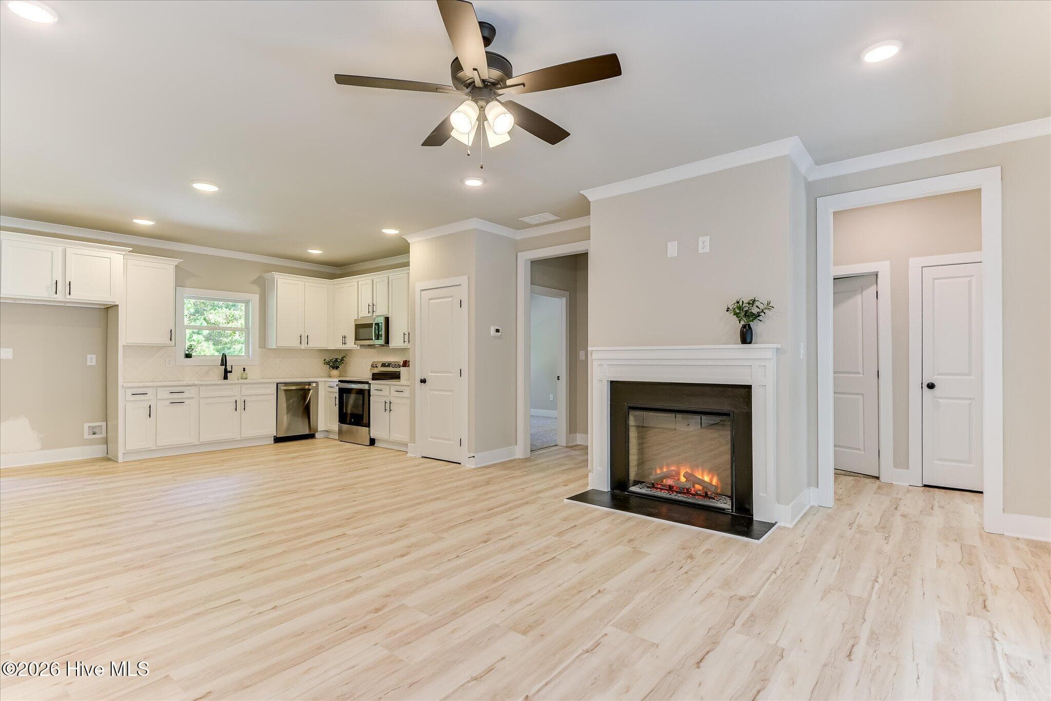 Open, split floor plan, kitchen/living/dining, hallway to Guest Bedrooms - 1198 Sunset Cove, Tignall, GA 30668