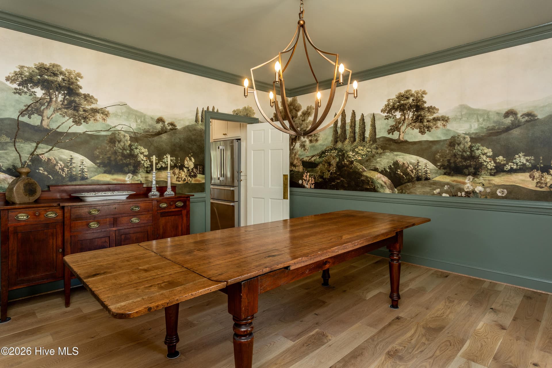 Old World Charm in this large dining room with beautiful wallpaper mural and fabulous chandelier. - 5050 Country Club Drive N, Wilson, NC 27896