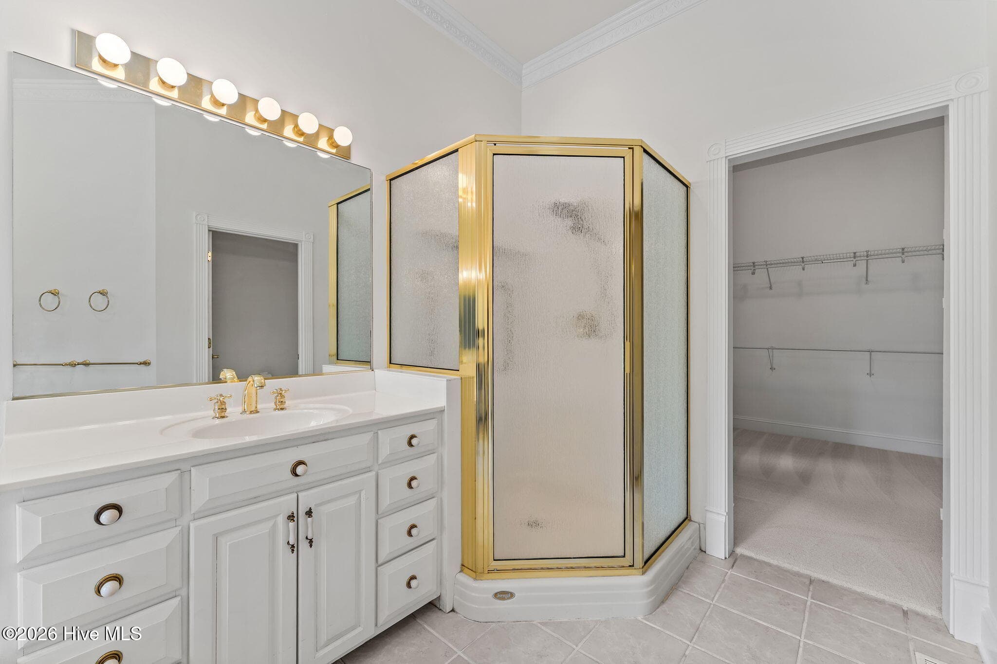 Primary bathroom with double sinks, separate walk in shower and access to the closets. Private toilet room across from shower. - 22 Lochmere Drive, Pinehurst, NC 28374