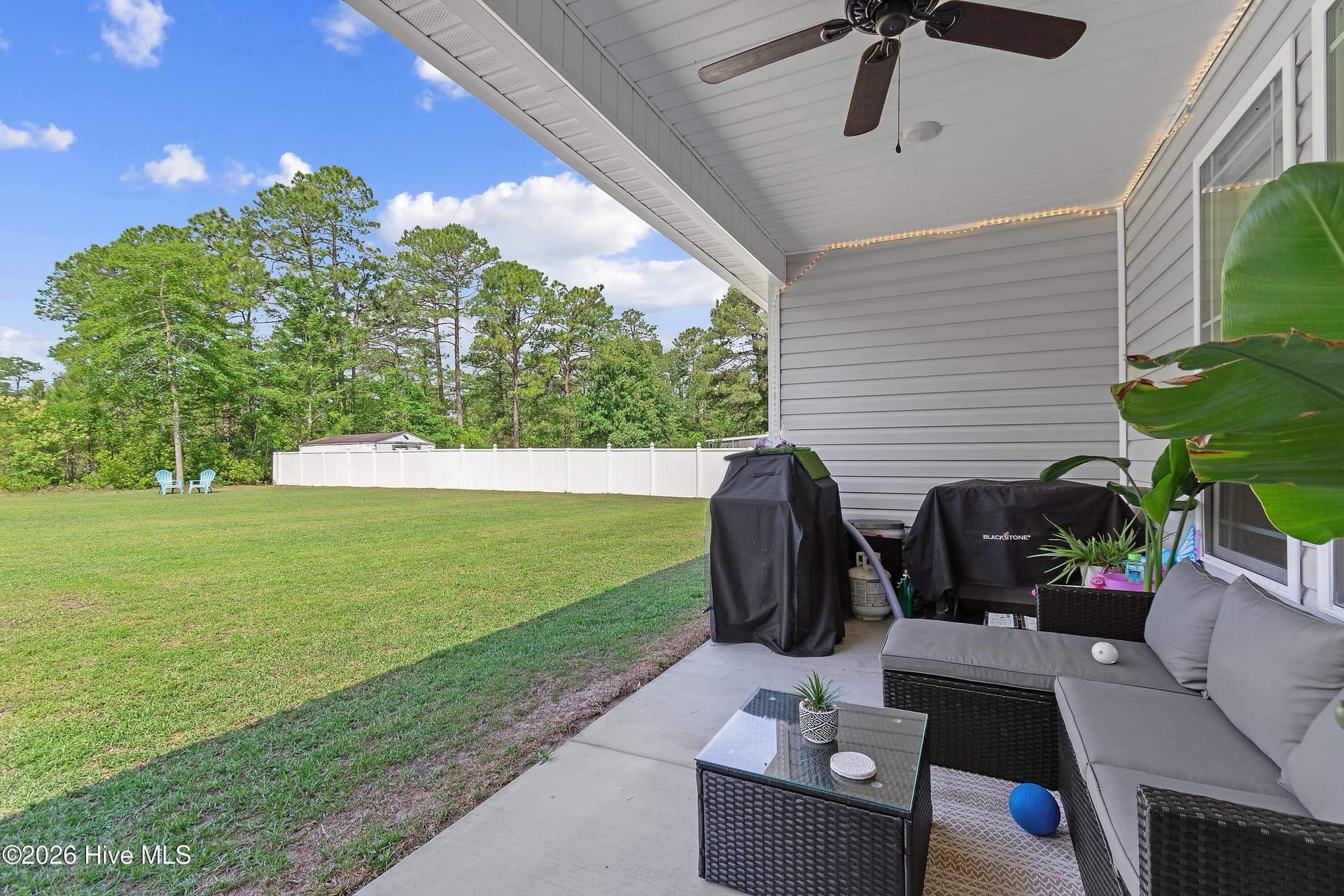 Just off the dining area, the covered outdoor overhang creates the perfect extension of the living space. This is ideal for grilling, dining, or relaxing outdoors while enjoying the fresh air. - 299 Boundaryline Drive NW, Calabash, NC 28467