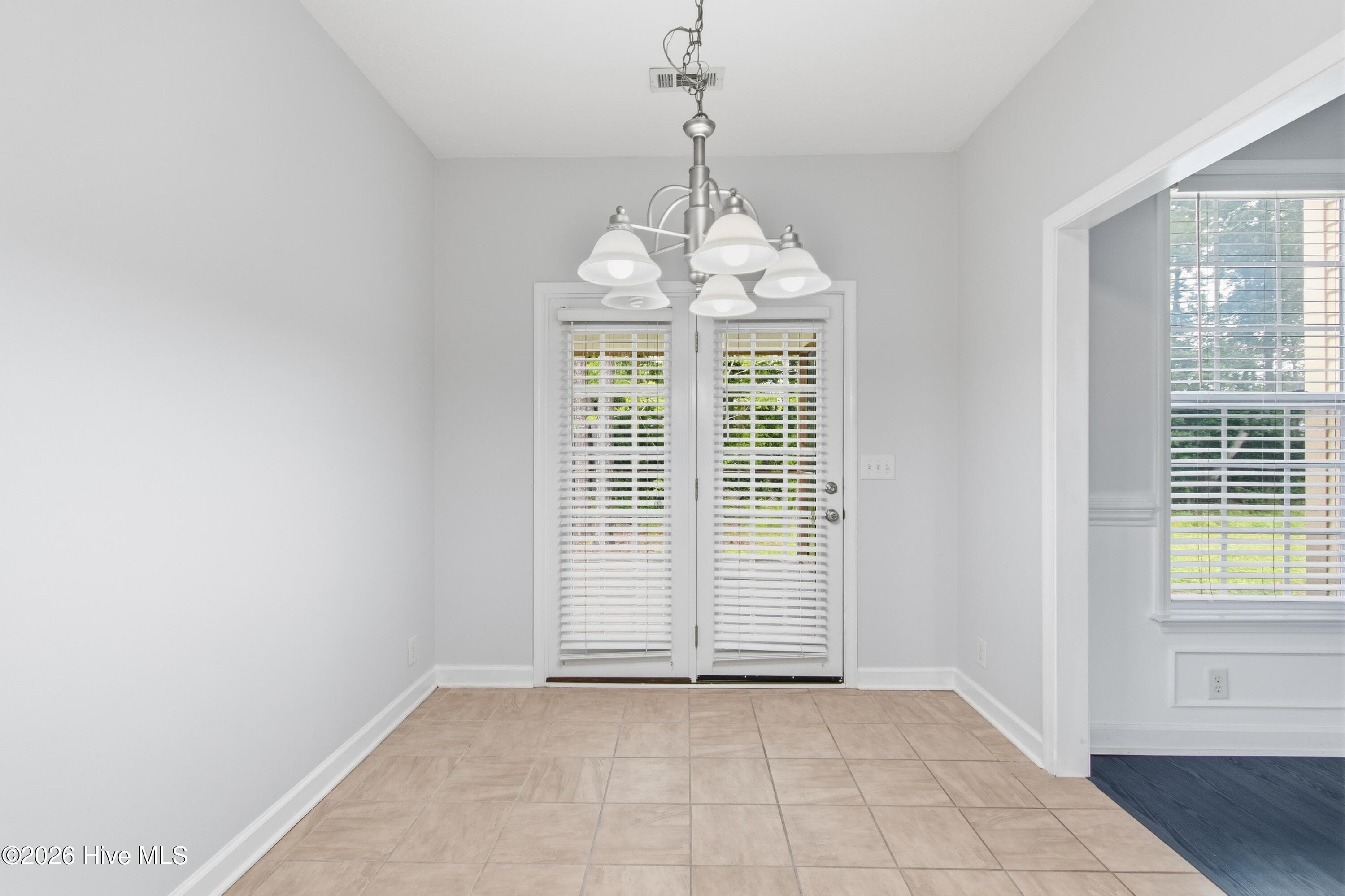 Breakfast nook attached to kitchen. Exit these doors to access the large screened porch. - 709 E Pipers Glen, Shallotte, NC 28470