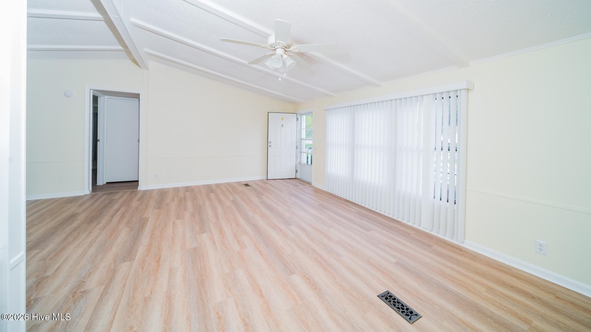 A ceiling fanand triple windows make this a welcoming room - 1076 Clubview Lane SW, Calabash, NC 28467